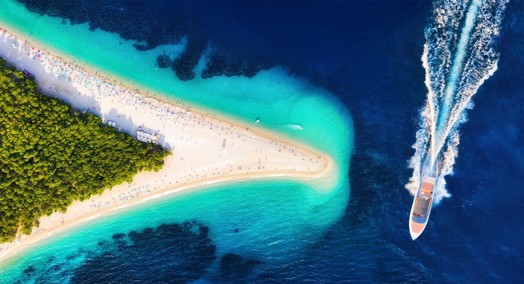 Yacht sailing near Golden Horn Beach in Croatia, aerial view